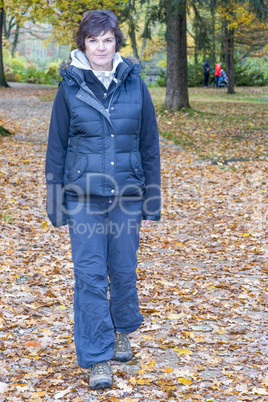 Woman runs in the autumn wood