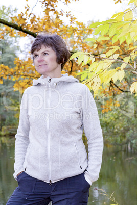 Woman enjoys the autumn wood