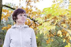 Woman enjoys the autumn wood