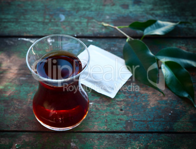 Typical Turkish glass for tea with tea inside, selectiv focus