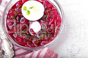 Bowl of beetroot soup with sour cream and eggs.