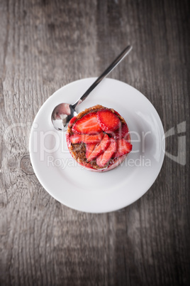 Strawberry and custard tart on a white plate