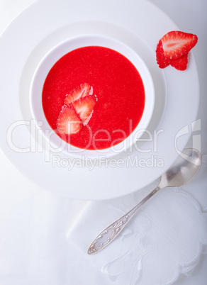 Strawberry soup served on a white plate