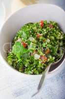 Quinoa tabbouleh salad on a wooden table