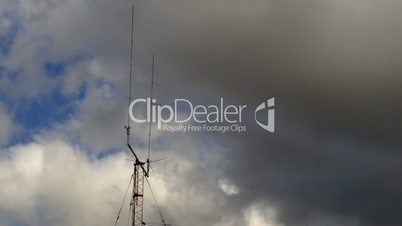 Home based dual spike Telecommunications antenna tower with storm clouds time lapse