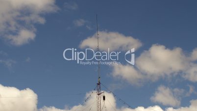 Home based single spike Telecommunications antenna tower heavy clouds day time lapse