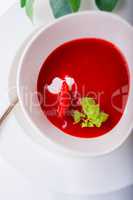 Strawberry soup with mint in a white plate