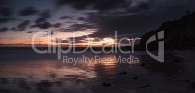 Rain clouds over Crescent Bay at sunset