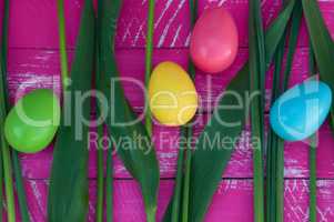 Easter pink background with colorful chocolate eggs