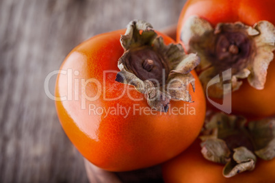 Persimmons on a wooden table