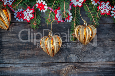 New Year and Christmas background with toys and spruce branches on a gray wooden background