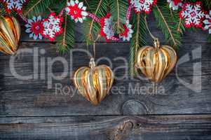 New Year and Christmas background with toys and spruce branches on a gray wooden background