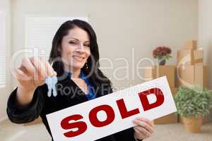 Hispanic Female Real Estate Agent with Sold Sign and Keys in Roo