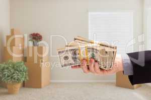 Handing Over Cash In Room with Packed Moving Boxes