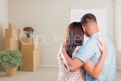Military Couple Facing Empty Room with Packed Moving and Potted