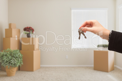 Handing Over House Keys In Room with Packed Moving Boxes