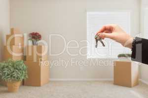 Handing Over House Keys In Room with Packed Moving Boxes