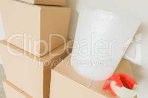Variety of Packed Moving Boxes In Empty Room