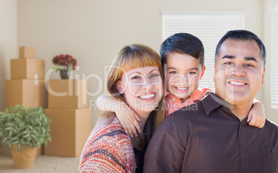 Mixed Race Family with Baby in Room with Packed Moving Boxes