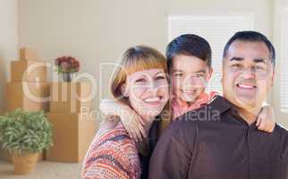 Mixed Race Family with Baby in Room with Packed Moving Boxes