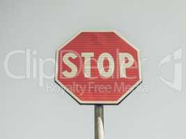 Vintage looking Stop sign over blue sky