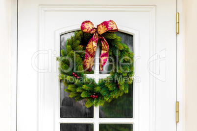 Christmas wreath on a white home doors