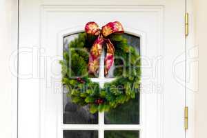 Christmas wreath on a white home doors