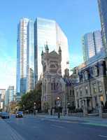 High rise with old church.