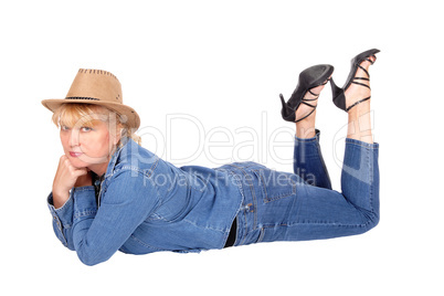 Woman lying on floor with cowboy hat.