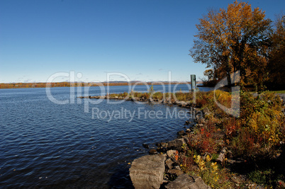 Peaceful lake under blue sky.