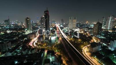 Time lapse shot of night life in the big city, lighted skyscraper, traffic, intersection, Bangkok, Thailand