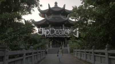 Woman having touristic walk in Bai Dinh Temple area, Vietnam