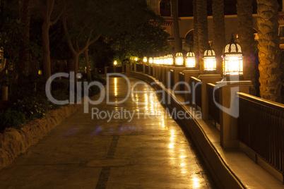 Empty footpath and lanterns at night photo