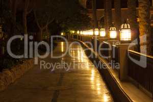 Empty footpath and lanterns at night photo