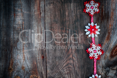 Felt snowflakes on a red ribbon to the left the empty space