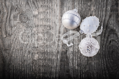 White christmas balls on a wooden background.