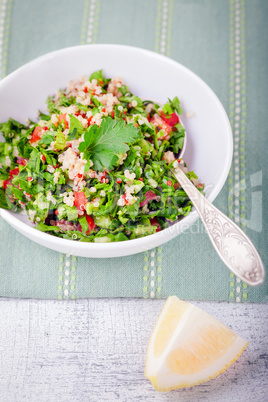 Quinoa tabbouleh salad on a wooden table