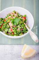 Quinoa tabbouleh salad on a wooden table