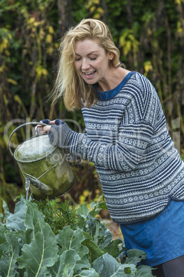 Middle Aged Woman Vegetable Gardening Watering Can