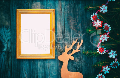 empty picture frame on a gray wooden surface with Christmas deco
