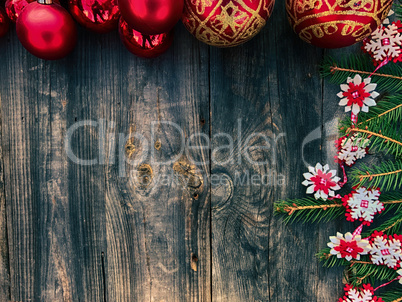 Christmas toys and decorated fir tree branch on a gray wooden su