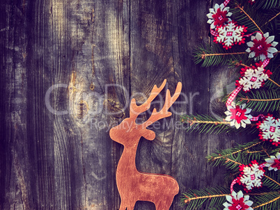 Toy wooden deer with decorated fir branches