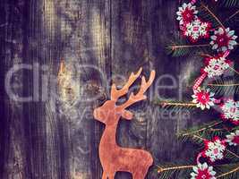 Toy wooden deer with decorated fir branches