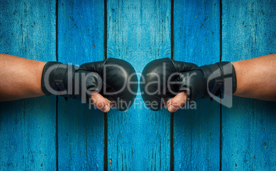 two fists in boxing gloves facing each other, vintage toning
