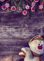 Christmas background with branches of spruce and snowman textile