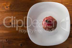 Ripe pomegranate on a white plate