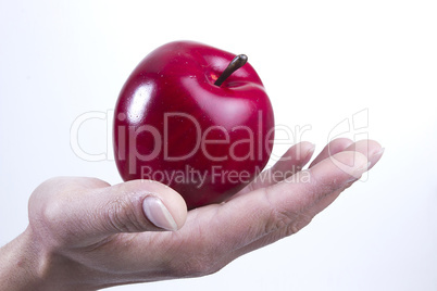 Arm and hand holding an apple
