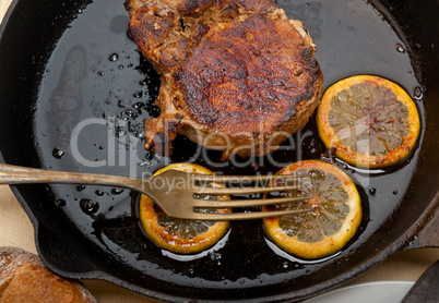 pork chop seared on iron skillet