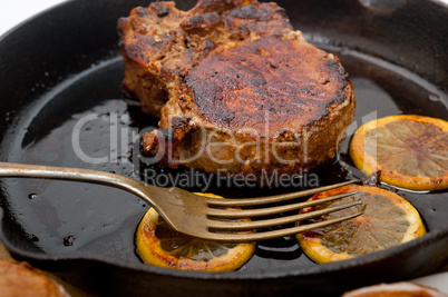 pork chop seared on iron skillet