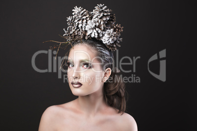 Elegant Girl in the New Year Wreath of Pine Cones